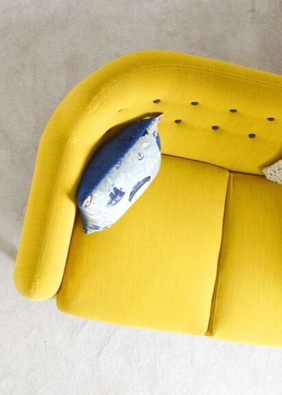 Yellow couch in therapy office.